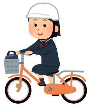 ヘルメットをかぶり自転車に乗る学生の画像